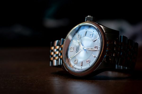 silver and blue analog watch at 10 10