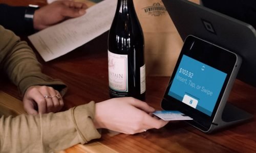 person playing card on POS machine